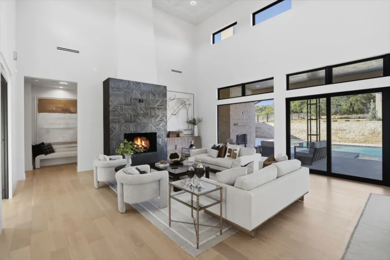 Living room with clerestory windows, a coffered ceiling and sliding glass doors to the pool in Boerne, TX