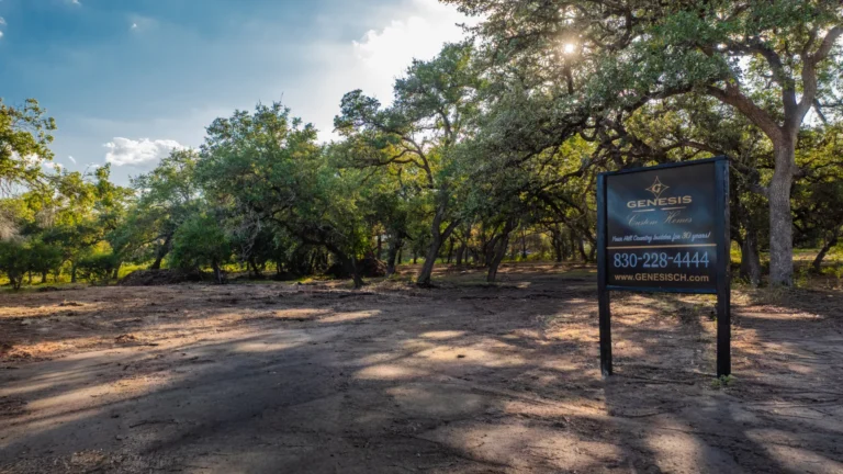 Genesis Custom Homes sign planted in the ground on Lot 31 in Pecan Springs - a custom homesite available to be built on in Boerne, TX