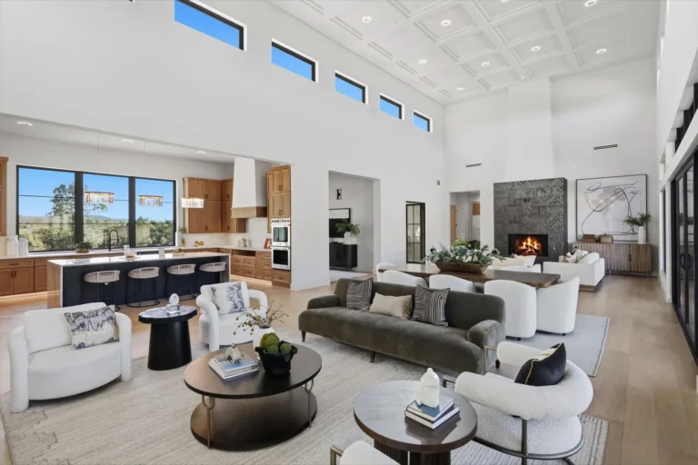 Open-concept great room flowing into a white oak kitchen with a navy island and Hill Country views in Boerne, TX