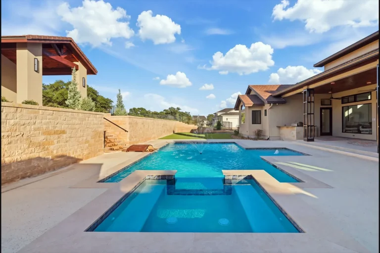 Resort-style pool and spa with limestone retaining walls and a cabana at a Boerne, TX custom home