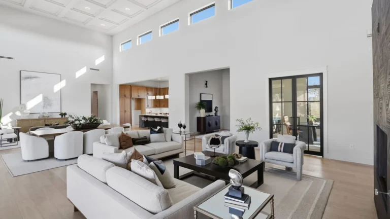 Open great room with clerestory windows, a coffered ceiling and steel-framed doors in a Boerne luxury custom home