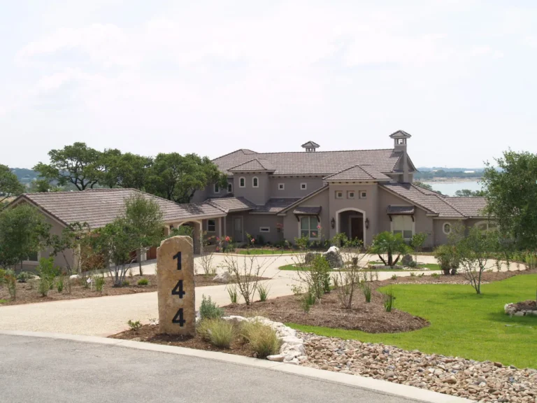 Stucco custom home with a tile roof and cupolas in Mystic Shores, with Canyon Lake visible beyond