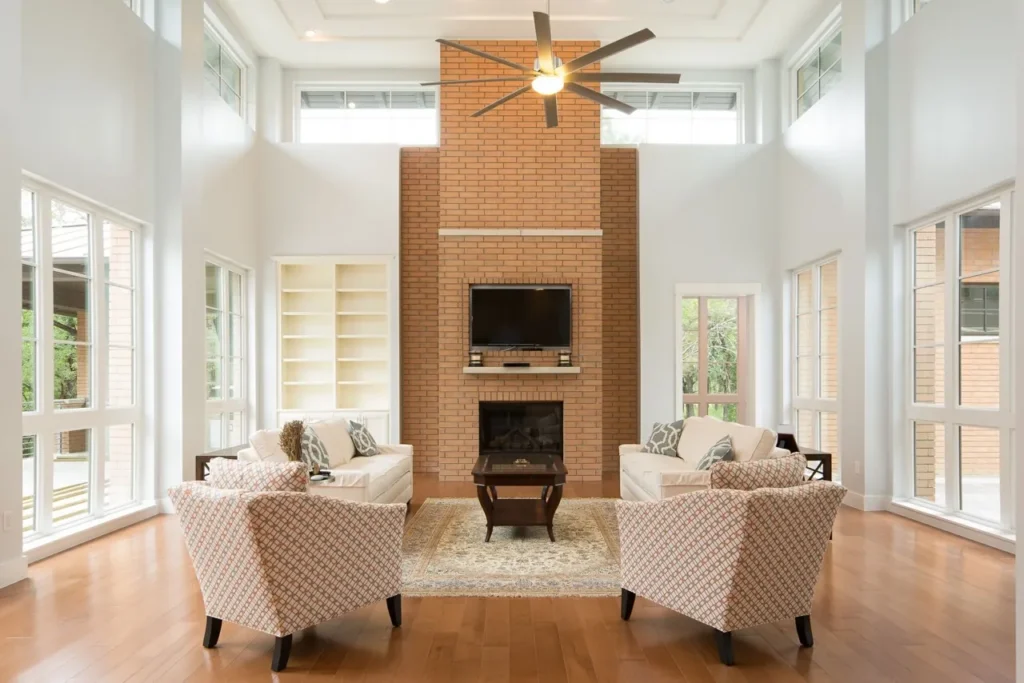 Two-story great room with a brick fireplace tower, clerestory windows and walls of glass