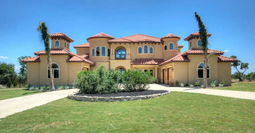 Mediterranean-style custom estate with a clay tile roof, arched windows and towers in the Terra Mont community of San Antonio