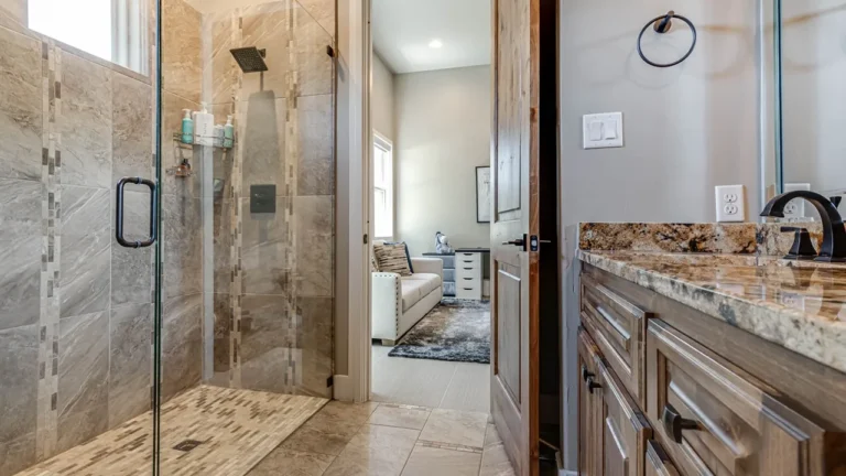 Guest bath with a frameless glass shower, porcelain tile accents and a granite-topped alder vanity