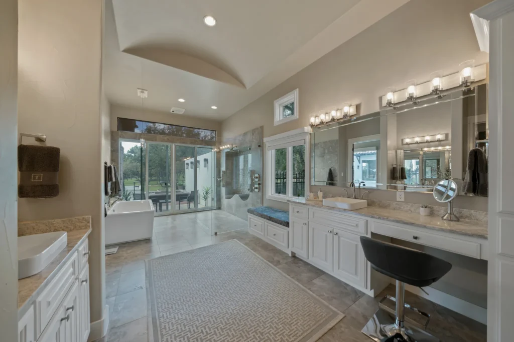 Primary bathroom with a freestanding tub, double vanities, makeup station and walk-in shower in The Dominion, San Antonio